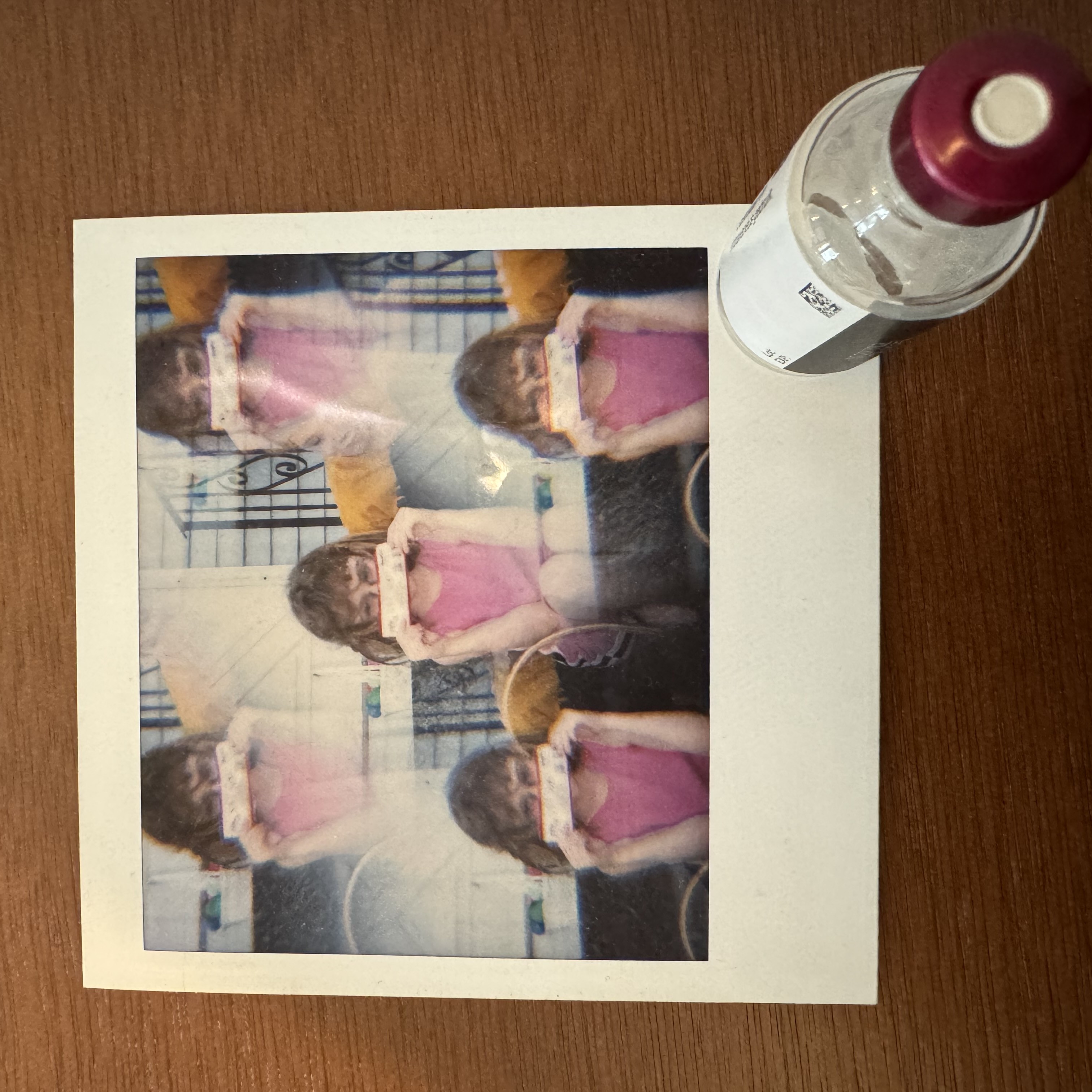 A framed photo print resting on a wooden table